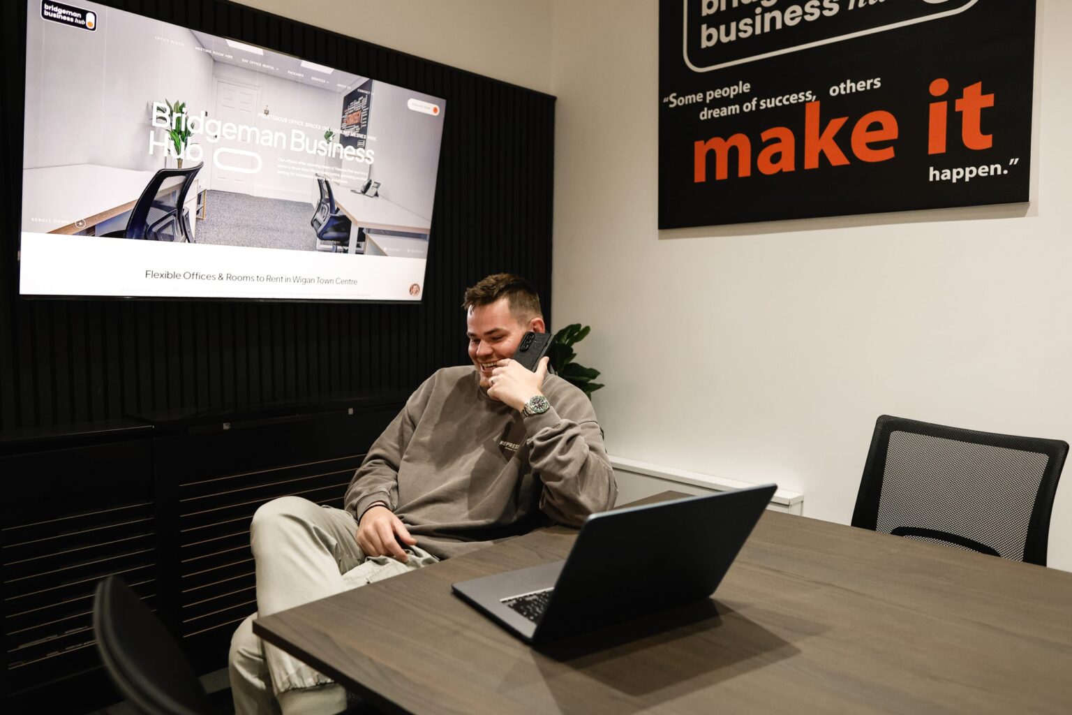 Sam speaking with a client from the Wigan studio