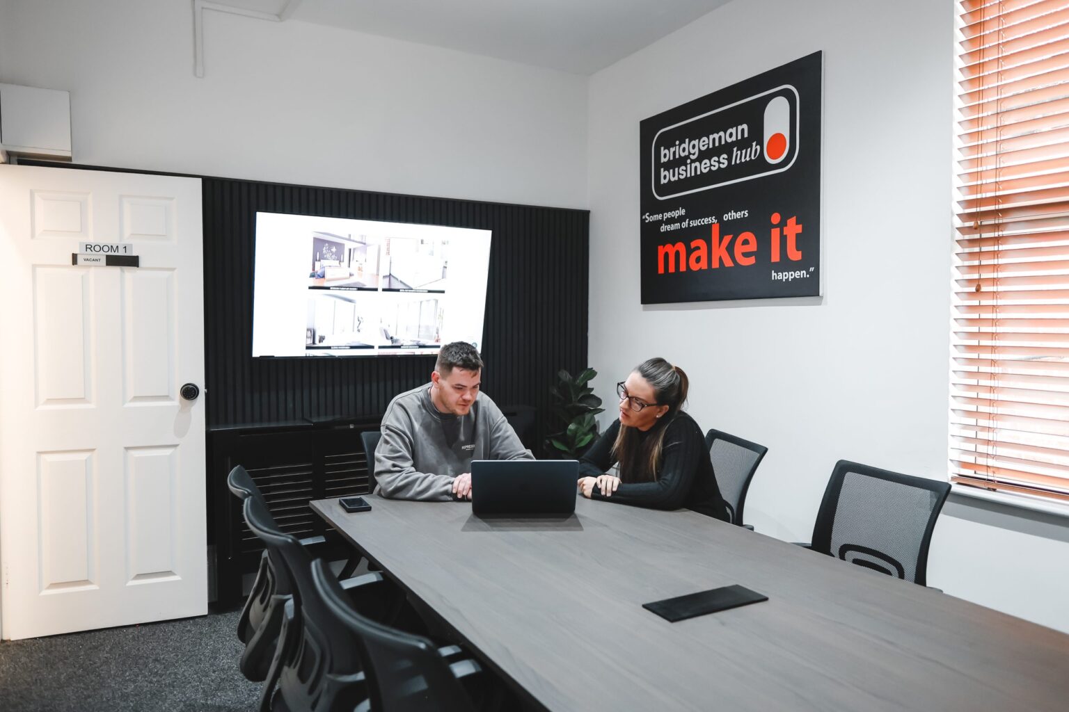 Sam and Trayana working together in the SJH Studio meeting room
